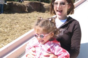 Mom and child sliding in sunglasses
